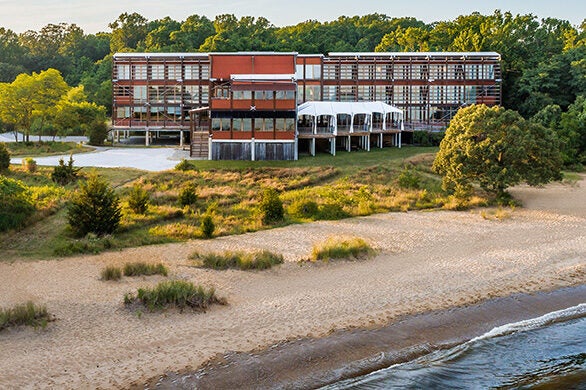 Rolling surf, a sandy beach, and grassy area off the back of the Philip Merrill Environmental Center.