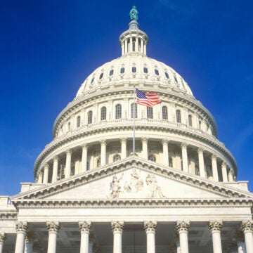 The dome of the U.S. Capitol building with the American flag flying.