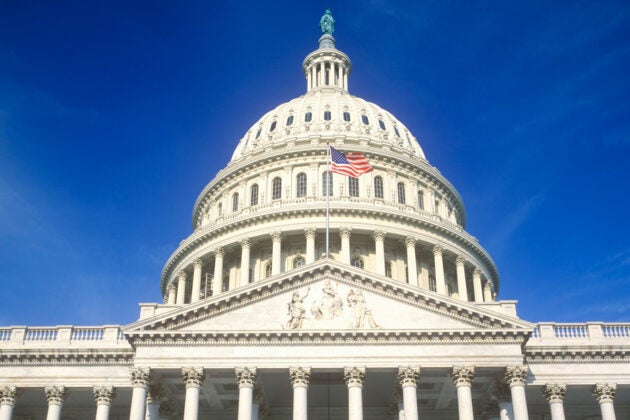 The dome of the U.S. Capitol building with the American flag flying.