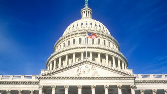The dome of the U.S. Capitol building with the American flag flying.