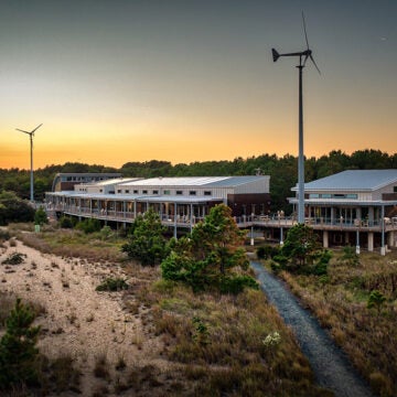 The Brock Environmental Center showing the main building, the classroom, and two wind turbines.