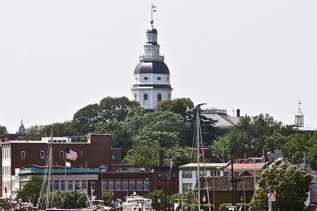 The Maryland State House dome rising above the historic buildings and sailboat masts of downtown Annapolis