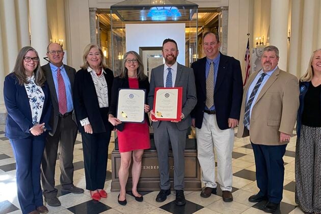 CBF educators and leaders, holding two resolutions, gather at the Maryland Statehouse.
