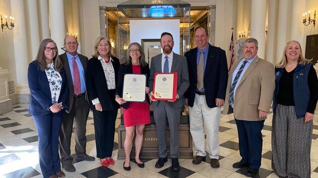CBF educators and leaders, holding two resolutions, gather at the Maryland Statehouse.