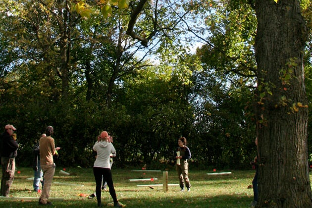A group of people prepare to plant trees