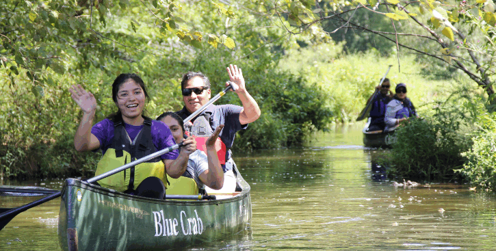 Students paddle a canoe.