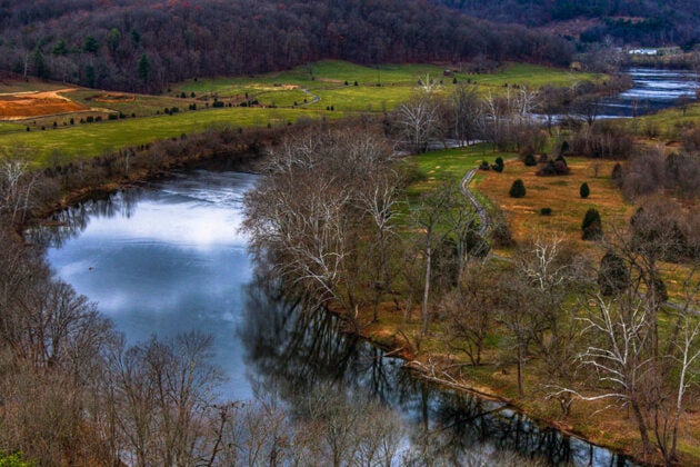 A river winds alongside fields.